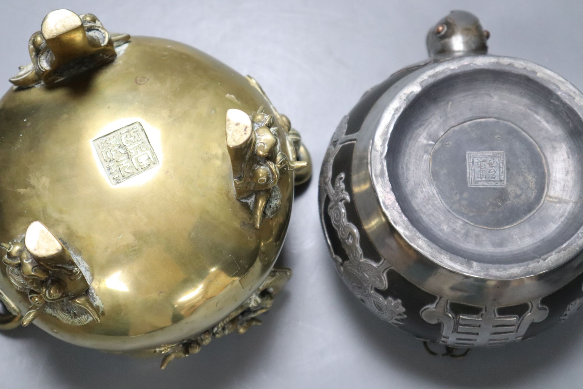 A Chinese bronze tripod censer, height 16cm, and a Chinese pewter-mounted Yixing pottery teapot, lacking lid (2)